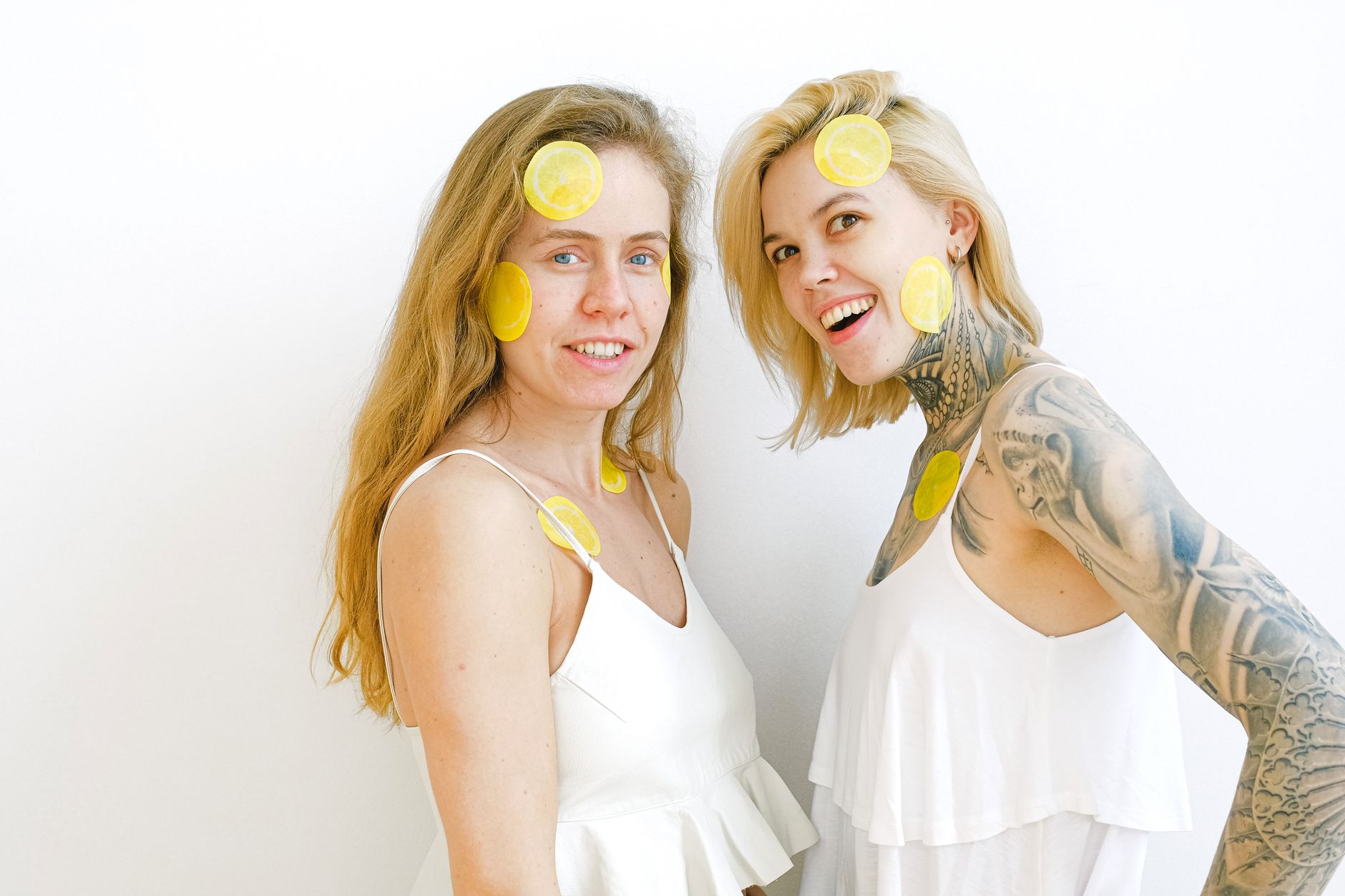 Hand holding a lemon against a vibrant yellow background, symbolizing freshness and the bright sensation of suction stimulation