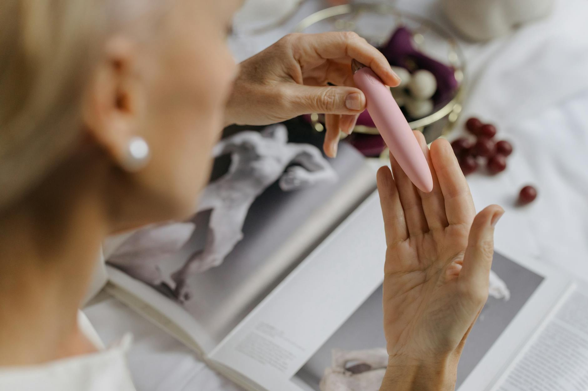 Woman holding colorful vibrators, expressing confidence in reclaiming pleasure